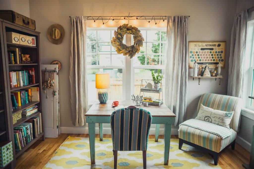 room with bookshelves, upholstered chair and desk